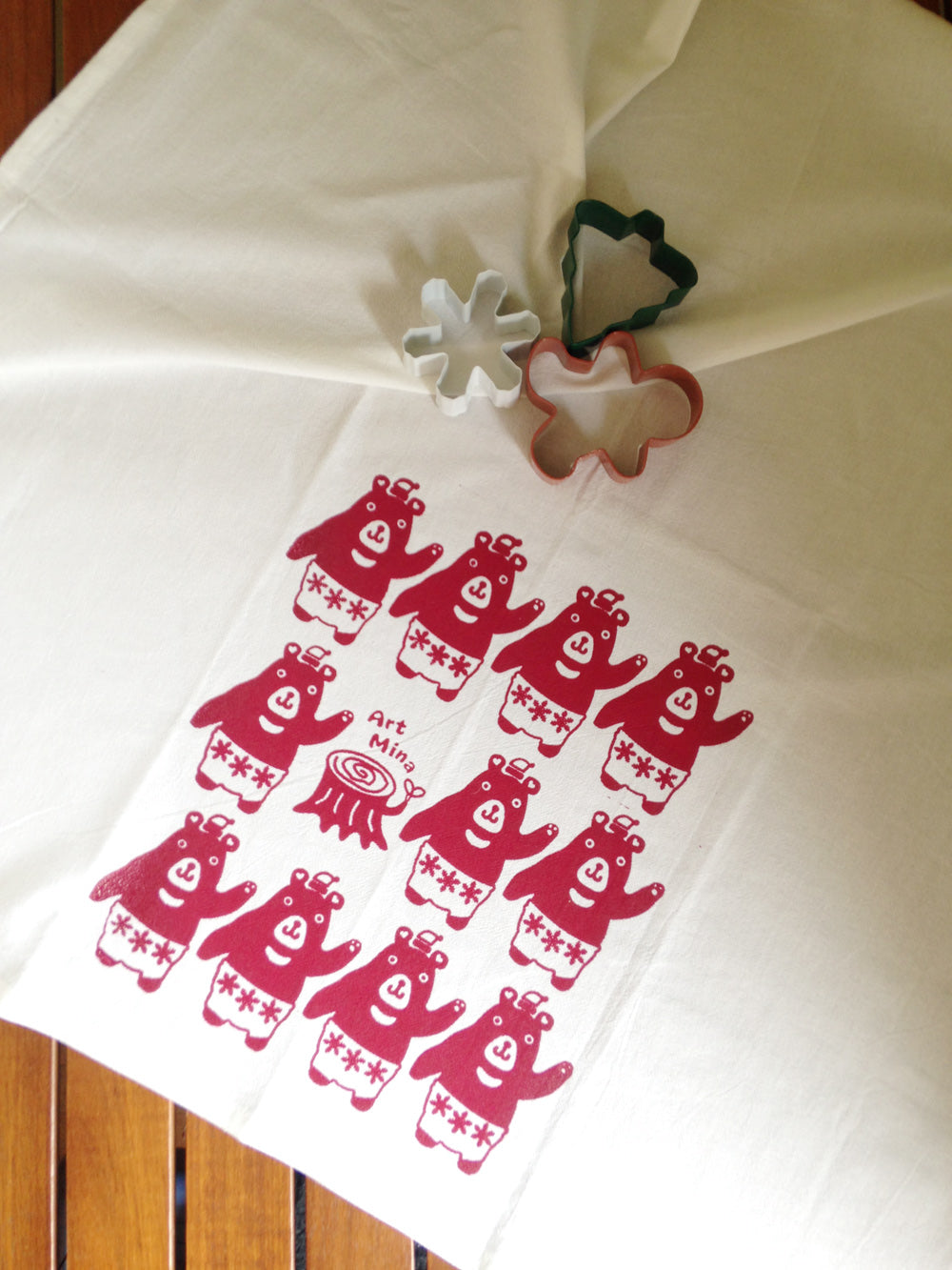 Funny Christmas bear design hand screen printed on white flour sack towel using non-toxic red water-based ink.