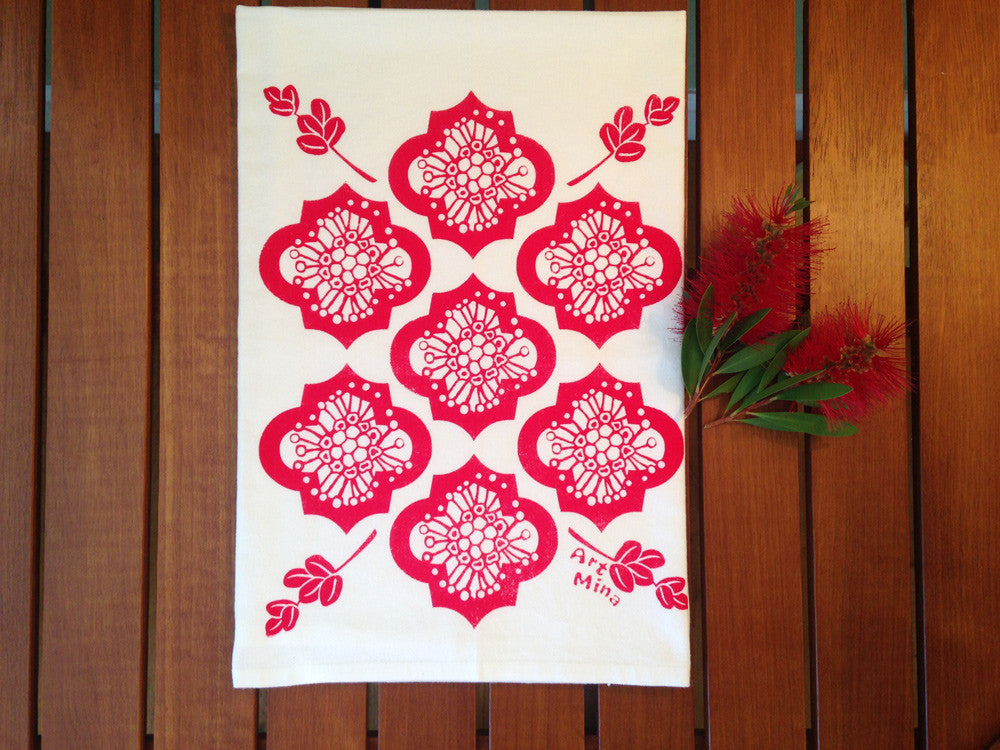Art Mina white tea towel with a red ʻŌhiʻa lehua floral pattern