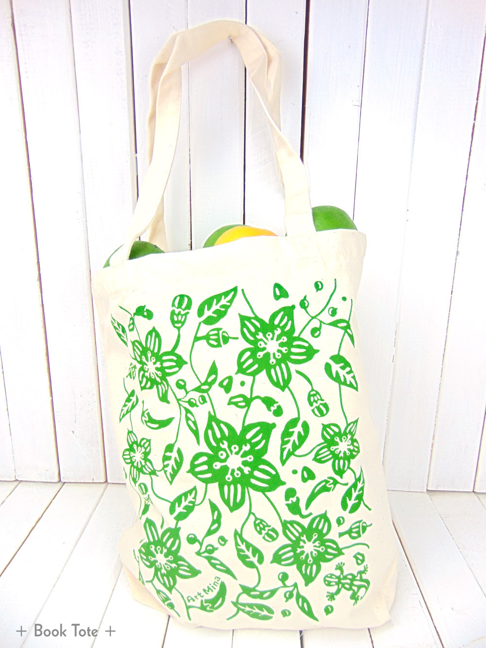 A photo of Art Mina Canvas Tote Bag "Aunty's Shishito Pepper Garden with Lucky Gecko "